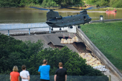 一架直升机将沙袋放入英格兰188岁的托德布鲁克大坝后，溢出到2019年剥落附近的城镇撤离。