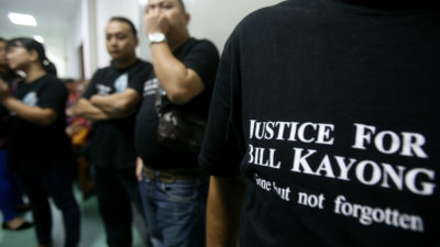 比尔·凯永的支持者在法庭外观看被控谋杀三名男子的审判。
